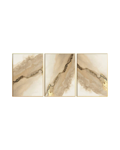 Modern minimalist abstract triptych canvas prints featuring fluid marble geode textures, shimmering gold foil veins, and organic watercolor crystal layers in cream white, beige, and warm tan.