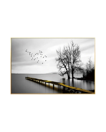 Landscape canvas print featuring a black and white photography scene of a calm lake with bare trees and a flock of birds, highlighted by a long wooden pier with a gold-colored pathway stretching into the water.