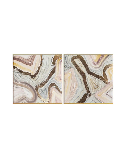 Modern abstract geode marble diptych wall art featuring swirling pastel pink, beige, and grey fluid patterns with glittery gold accents in gold frames.