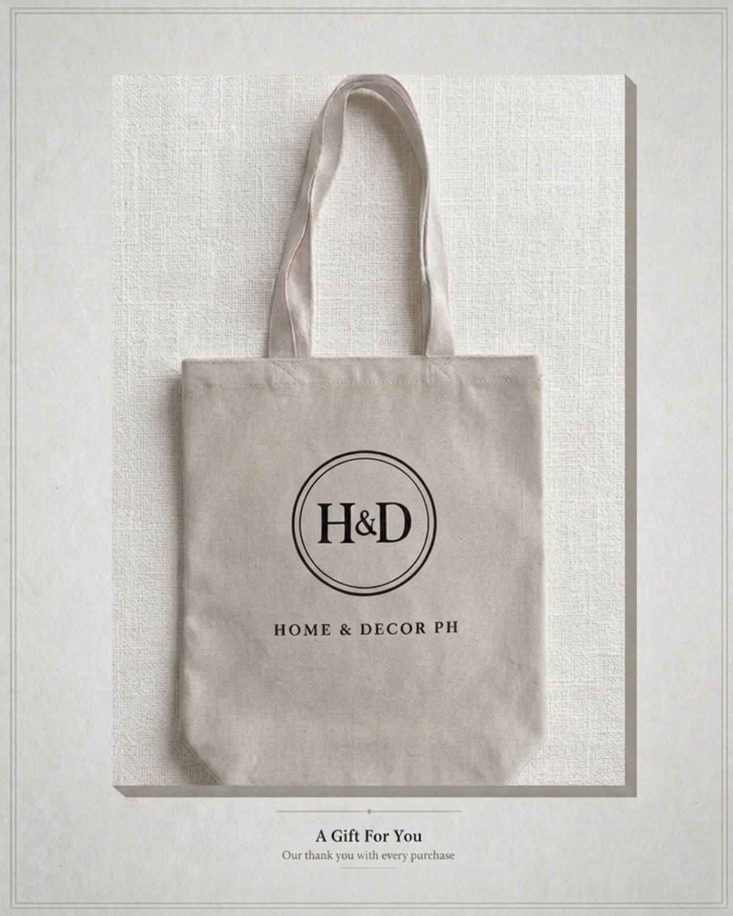Complimentary premium canvas tote bag branded with the Home & Decor PH circular logo on a neutral linen background as a free gift with purchase