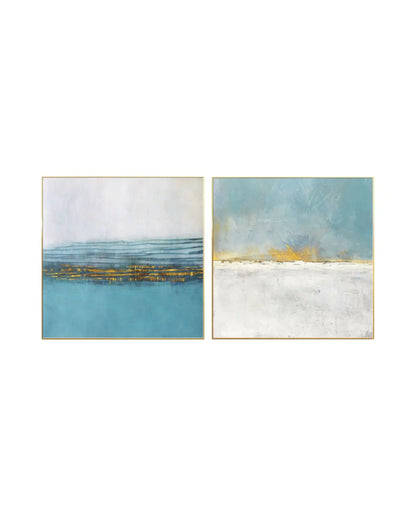 Modern abstract landscape diptych wall art with textured turquoise blue and white horizons accented by shimmering gold foil in gold frames.