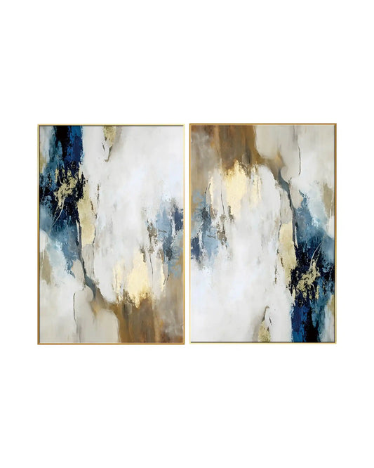 An abstract diptych painting featuring fluid, cloud-like patches of white, cream, and beige, contrasted by bold splashes of deep navy blue and textured metallic gold leaf accents throughout.