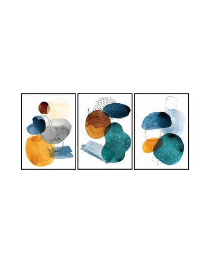 Modern minimalist abstract triptych canvas prints featuring fluid watercolor blobs, organic pebble shapes, fine pinstripe dashes, and delicate linework loops in teal, navy blue, marigold yellow, terracotta orange, and charcoal grey.